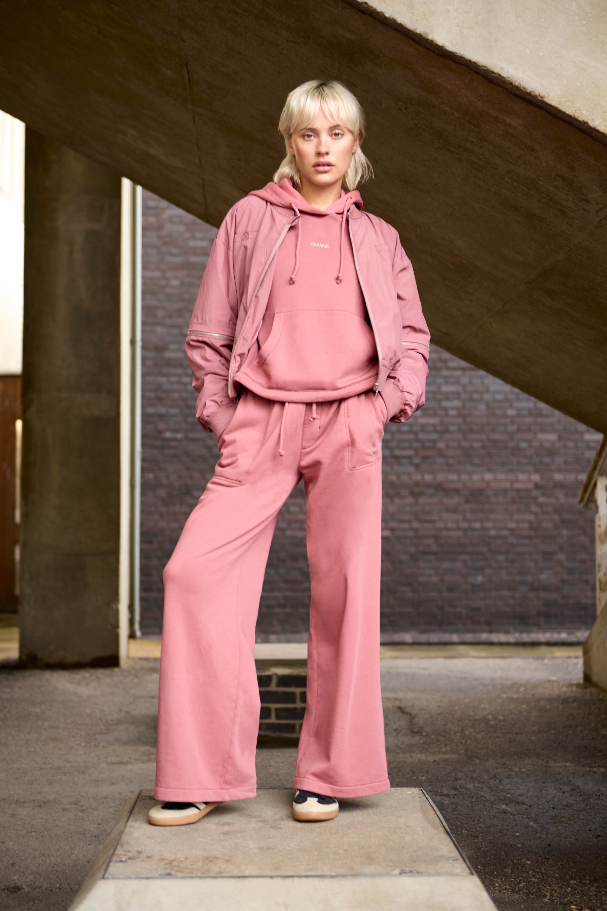 Guide to Athleisure Style with HRMN8 - model wearing pink track suit
