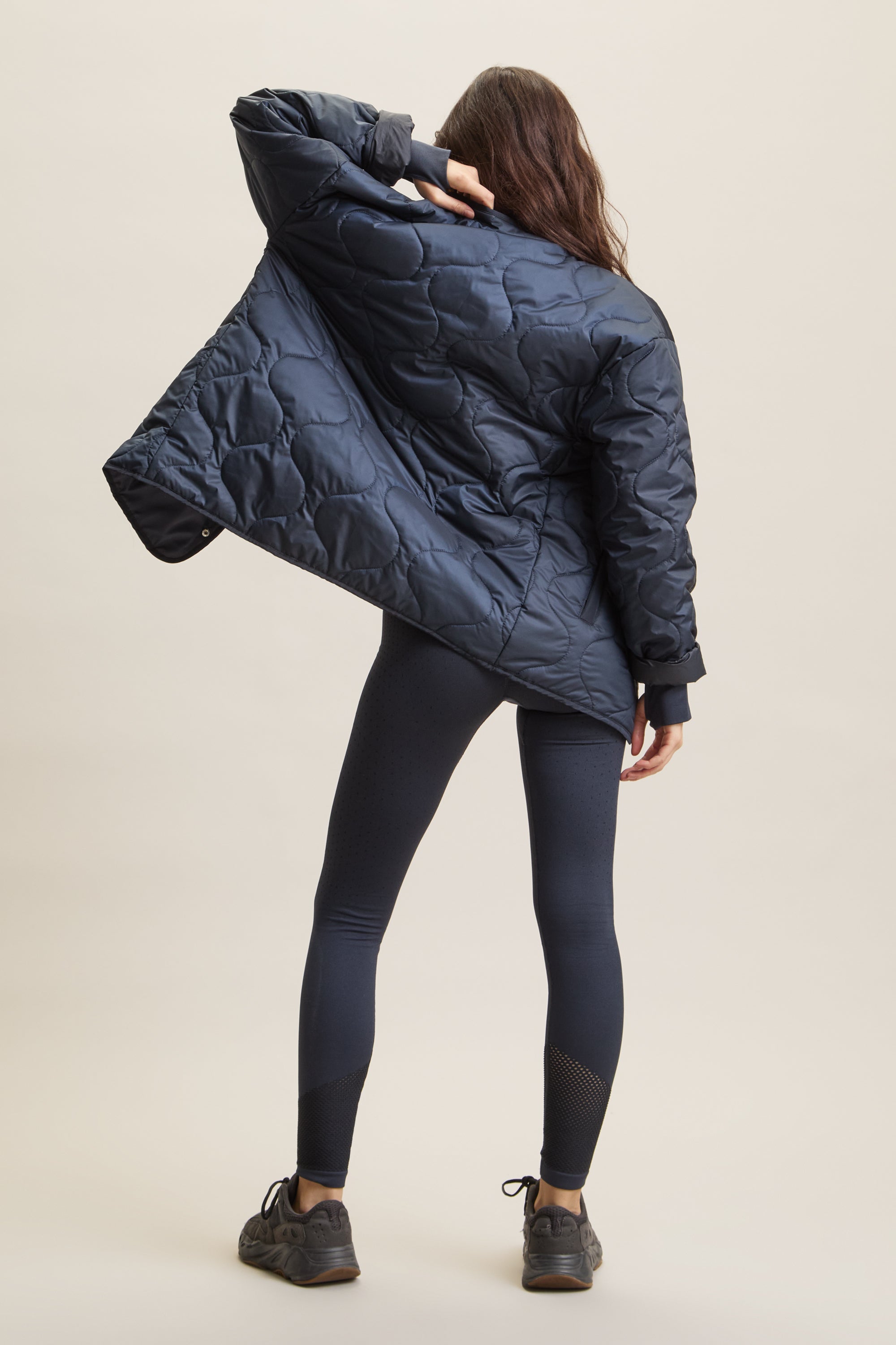 Women's HRMN8 navy dark blue wave-quilted jacket with chest pocket and side pockets, lightweight layering piece for athleisure, streetwear, and activewear. Versatile, breathable, and ideal for transitional weather and everyday movement.