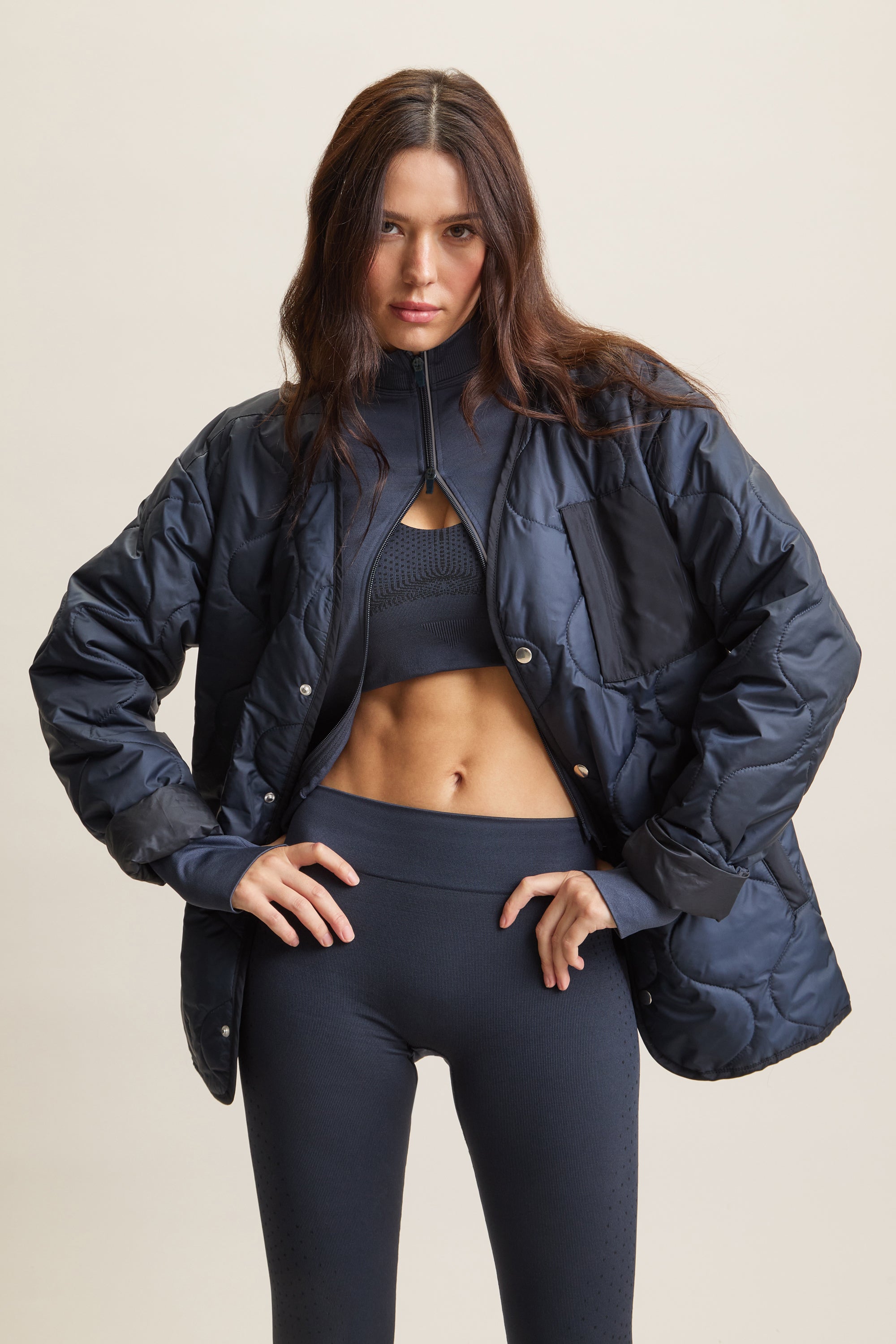 Women's contour sculpting zip-thru jacket with a fitted design for a sleek, flattering silhouette. Lightweight activewear zip-up with 3M reflective piping for visibility, a double-ended zipper for customizable styling, and thumbhole cuffs for a secure fit. Ideal for layering over activewear sets, gym workouts, running, yoga, and athleisure fashion. High-performance sculpting jacket for comfort, mobility, and effortless street style.