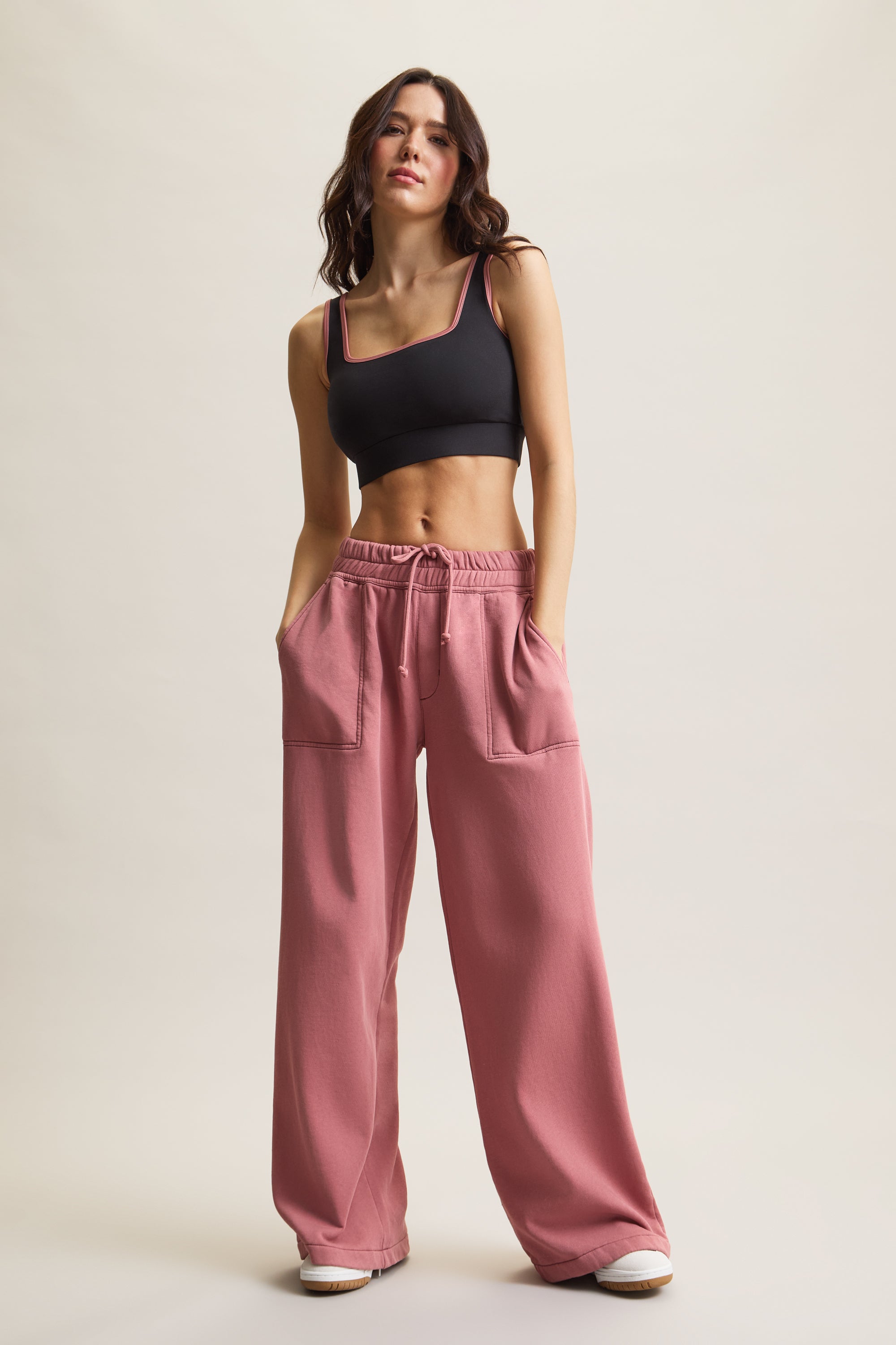 Women's HRMN8 sleek black longline sports bra with a square neckline, contrast binding, and a stylish cut-out back. Designed for medium support with a buttery-soft, second-skin feel. Perfect for athleisure, workouts, Pilates, gym wear, and everyday activewear. Flattering and breathable tank-style bra for women, ideal for low to medium-impact training. Contemporary activewear essential with sculpting fit and all-day comfort.