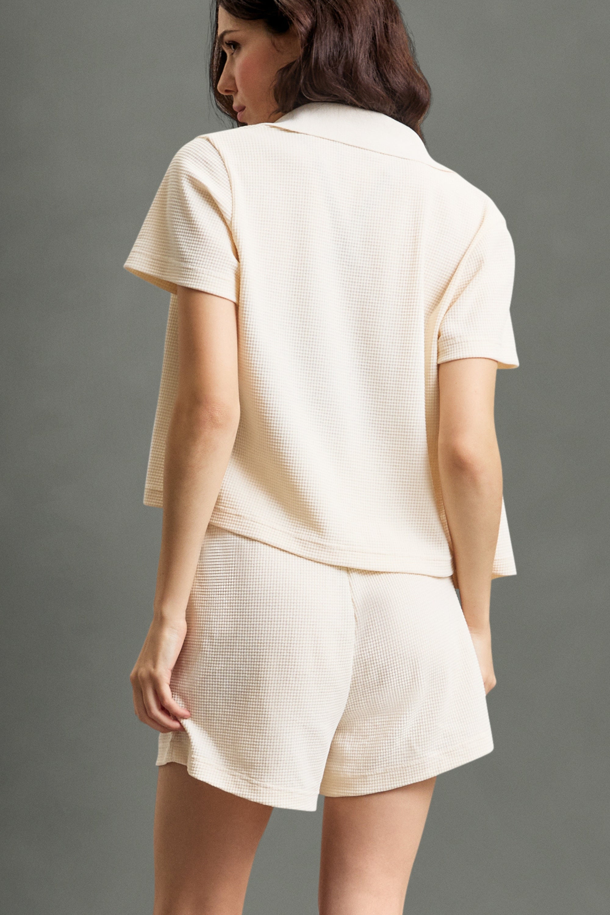 Women's HRMN8 beige cream off white resort-style waffle shirt, lightweight button-up shirt for layering, breathable textured fabric shirt, soft waffle-knit throw-on top, effortless activewear cover-up, beach-to-gym layering piece, relaxed fit casual shirt, co-ord resort wear set, premium loungewear-inspired activewear, versatile summer layering piece.