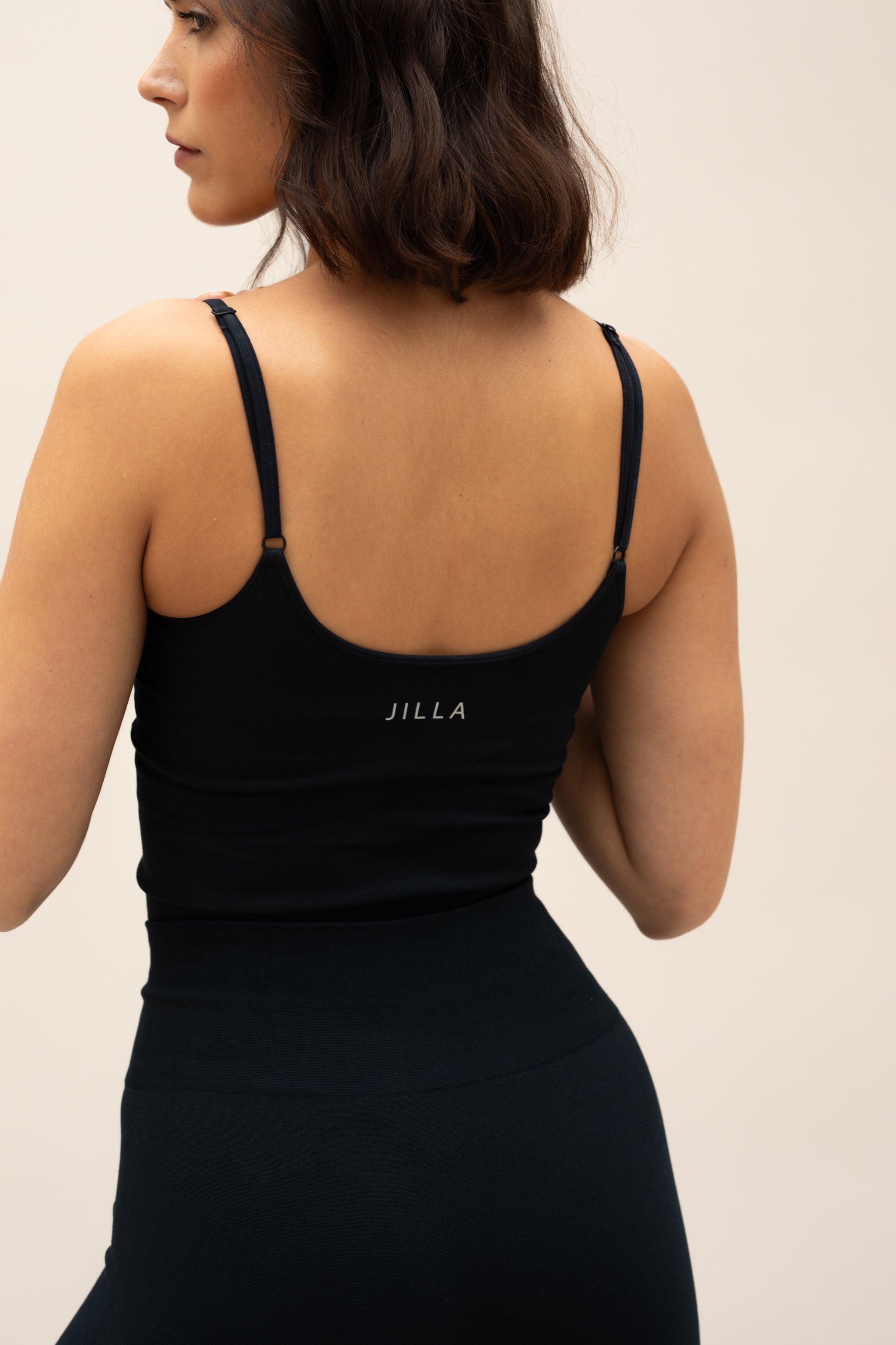Model wearing black top and black leggings for sustainable activewear Jilla