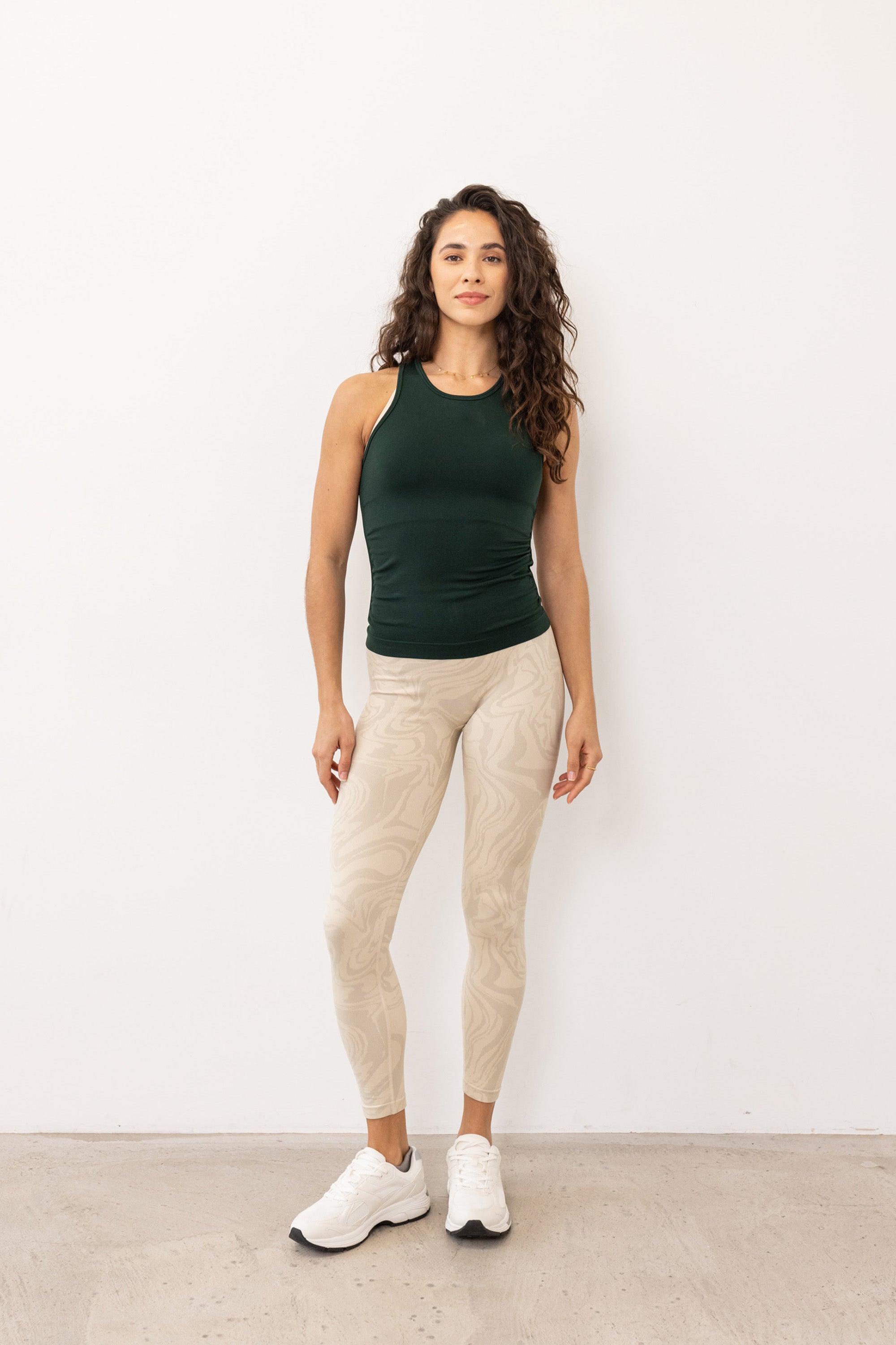 Dark green seamless recycled moisture wicking sleeveless tank top with side ruching for yoga, pilates, gym, cycling, running and exercise by sustainable activewear brand Jilla Active