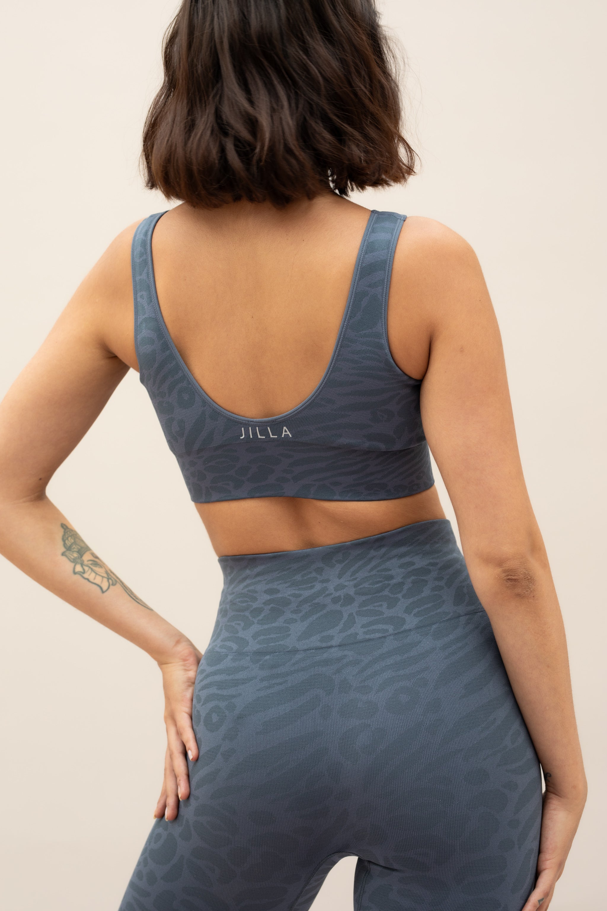 Blue leggings and blue recycled sports bra for sustainable activewear brand, Jilla.