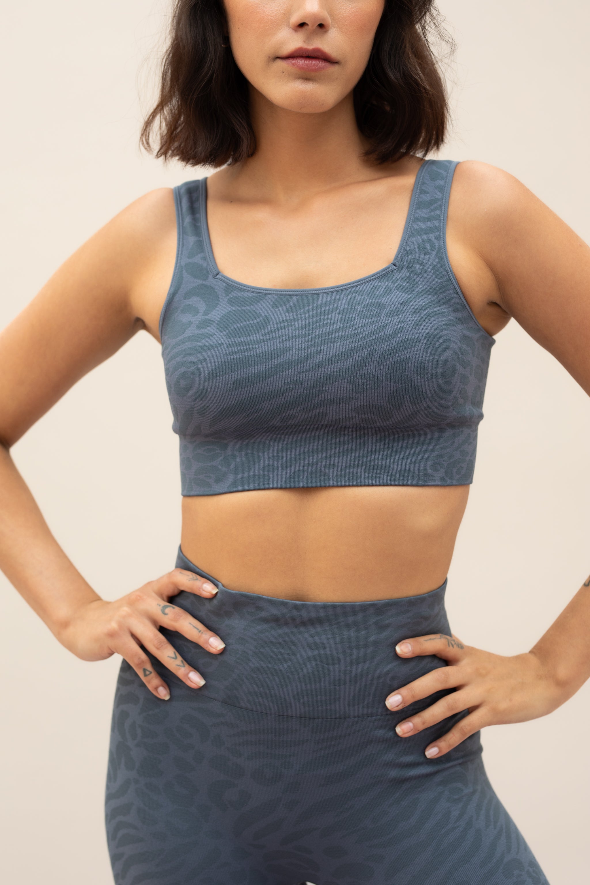 Blue leggings and blue recycled sports bra for sustainable activewear brand, Jilla.
