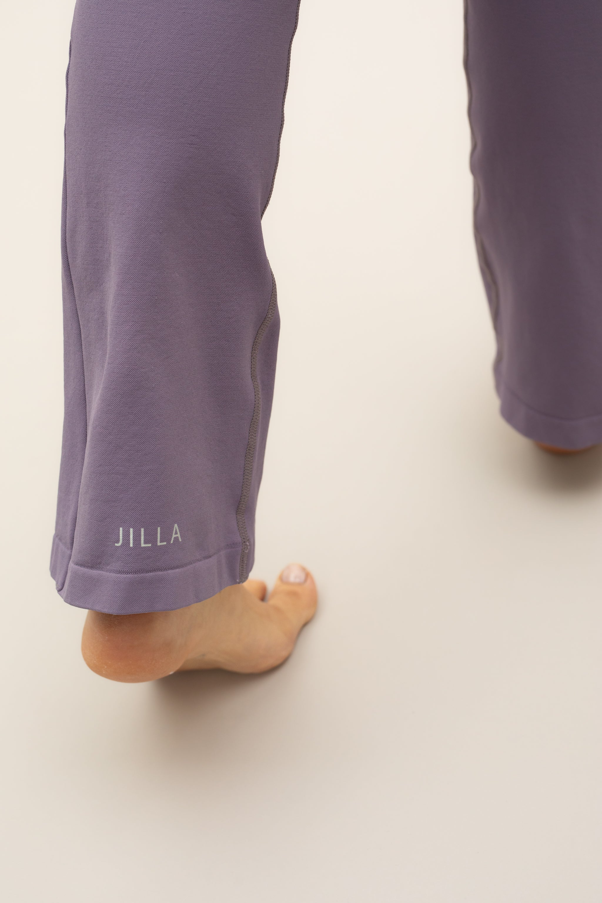 Purple flare leggings with purple supportive sports bra by sustainable women's activewear brand, Jilla. 