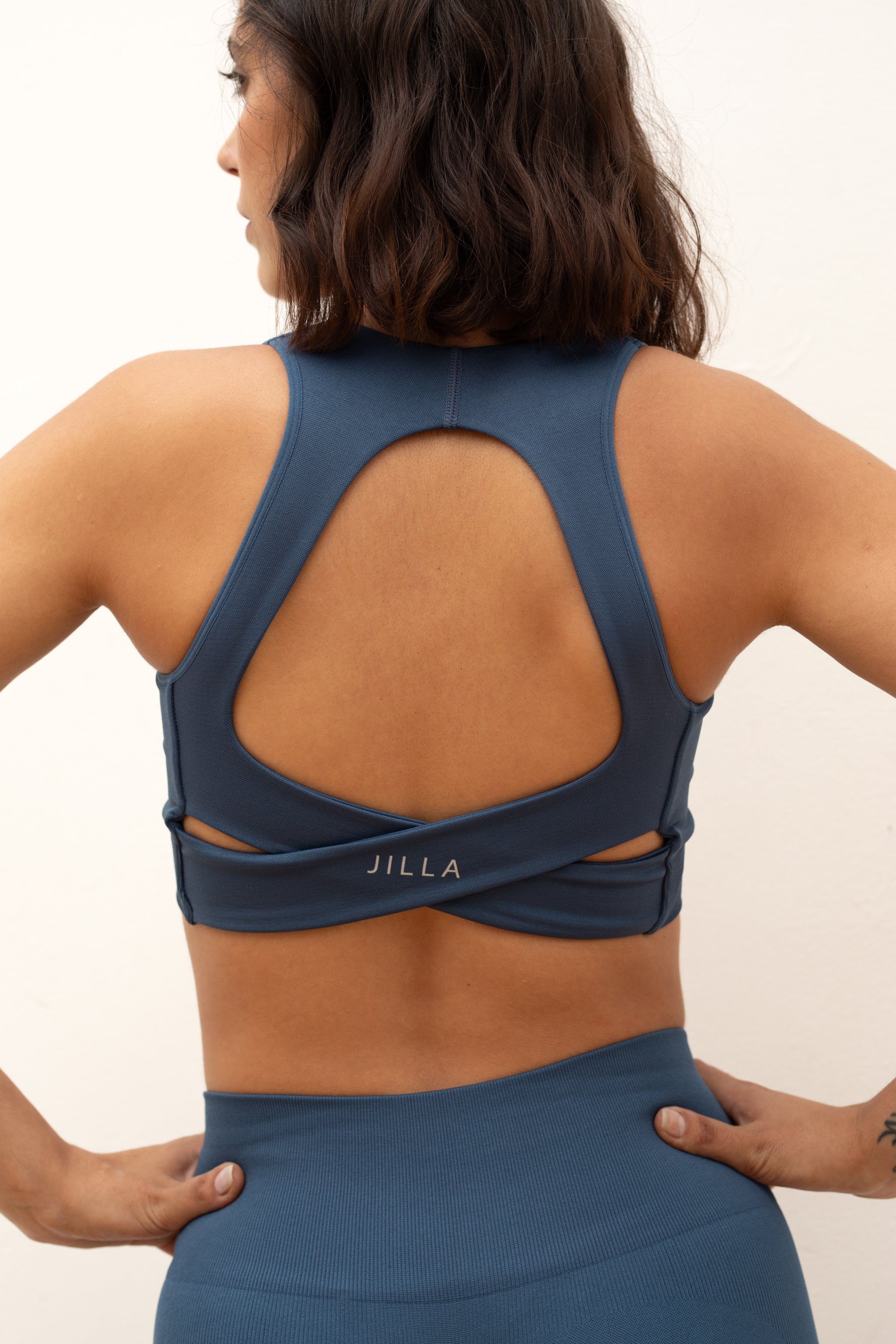 Blue V neck recycled supportive sports bra and leggings.