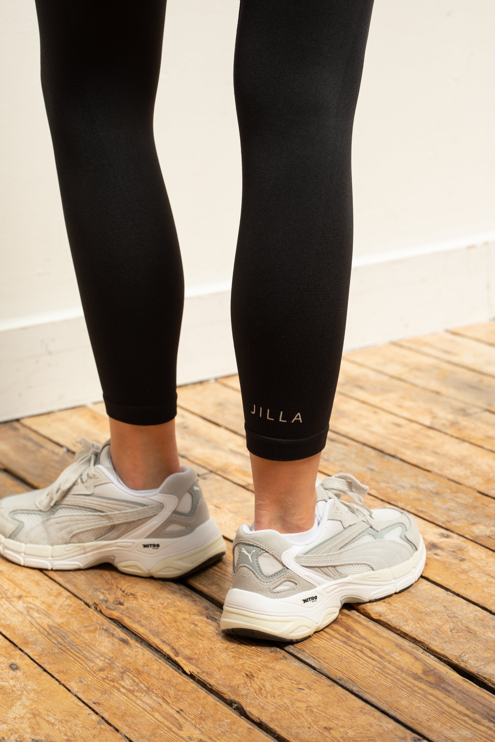 Black supportive sports bra and black recycled cropped leggings.