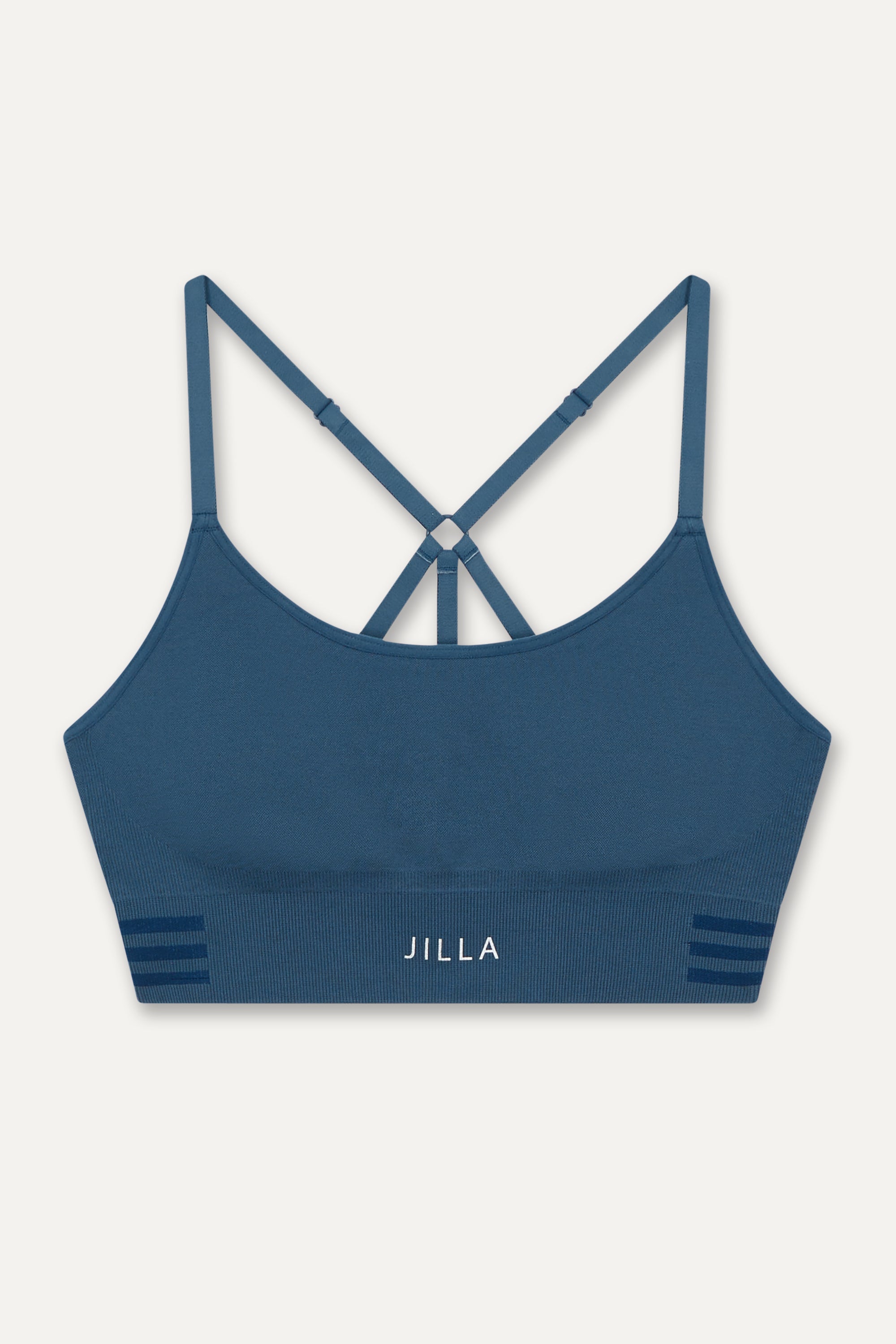 Meet our new denim blue Tone & Lift Recycled Sports Bra! Crafted for comfort and functionality, it's perfect for your active lifestyle. Made with sweat-wicking fabric and adjustable straps, it offers support and adaptability. With stylish details and light to medium support, it's ideal for yoga, pilates, and beyond. Elevate your workout with sustainable style by Jilla Active