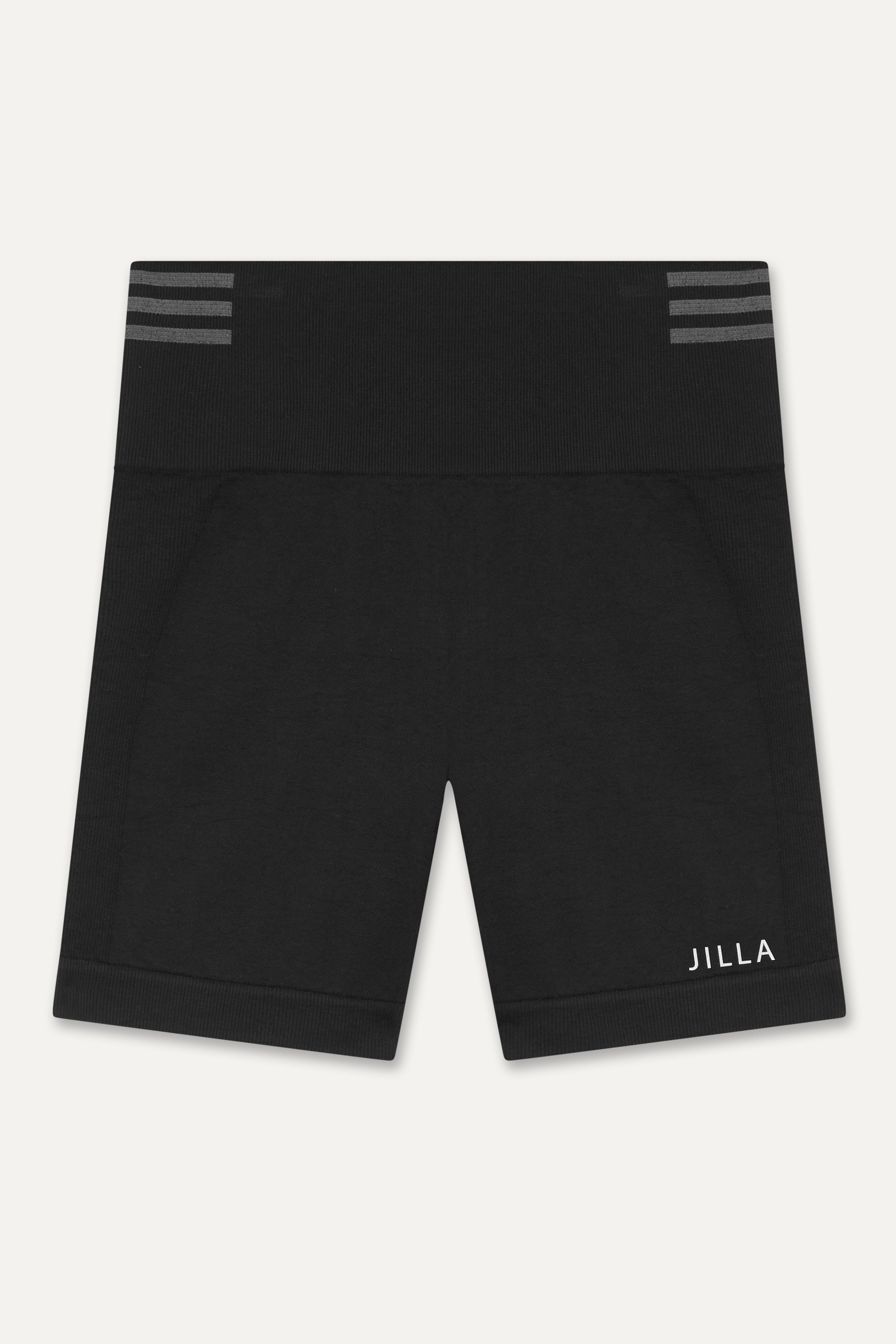 Introducing our black Tone & Lift Recycled Shorts: Your go-to for summer workouts! Made with four-way stretch fabric and ribbing panels, they offer a flattering fit for any activity. Featuring a high-rise ribbed waistband and 5" inseam, they ensure comfort and style. With contrasting colors and internal elastic, they're both fashionable and functional. Pair with our matching bra and Sky's The Limit Oversized T-shirt for a complete look. Sustainable activewear by Jilla Active