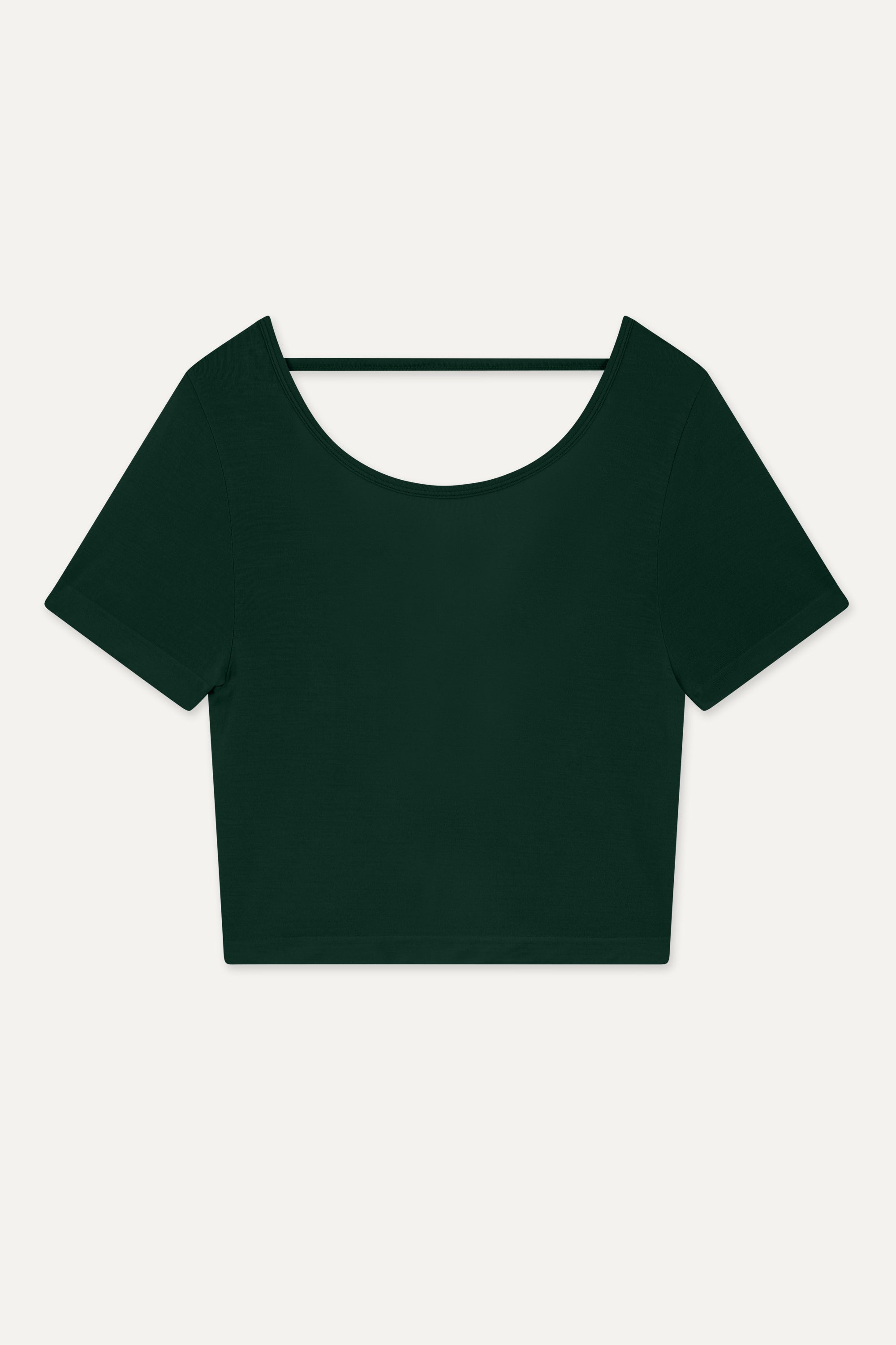 Meet our dark green Frances Modal Tee - your go-to for yoga or any workout! With a cropped length and low back, it's perfect for layering over leggings and a sports bra. Crafted from gentle Lenzing modal fabric blended with recycled polyamide, it offers unmatched softness and comfort. Cut to meet your leggings' waistband, it's a versatile must-have for your activewear collection. Experience comfort and style with Frances Modal Tee by Jilla Active