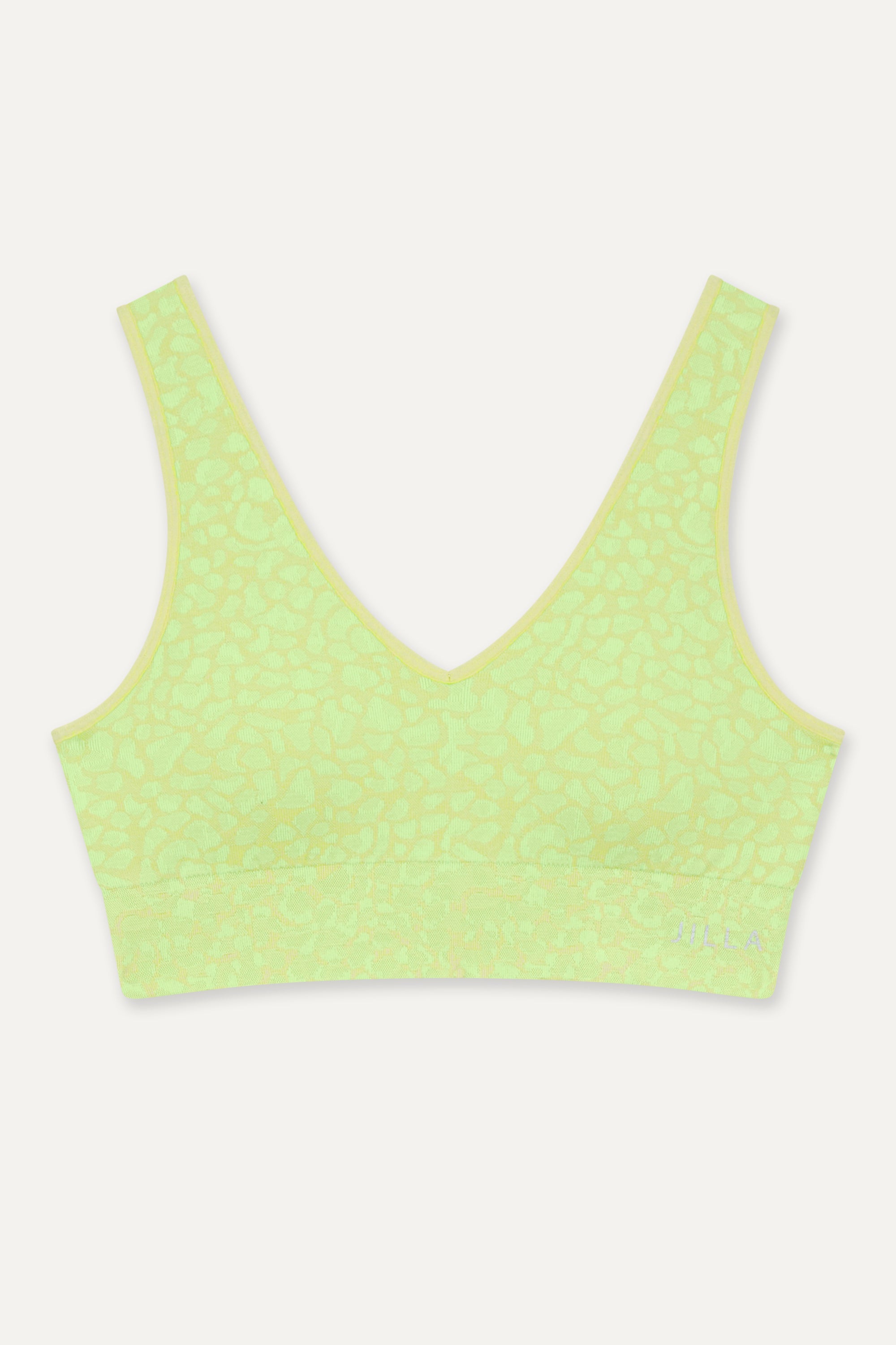 Get summer-ready with our green Sahara Recycled Sports Bra, seamlessly knitted in our new animal jacquard. Designed with a flattering V-neck shape, comfortable straps, and a wide underband, this bra offers light to medium support for low-impact studio exercise, cycling, and gym sessions. The double-layered fabric ensures support and flexibility, while removable pads allow you to customize your fit. Pair it with the matching shorts for a studio-to-street look from sustainable activewear brand.