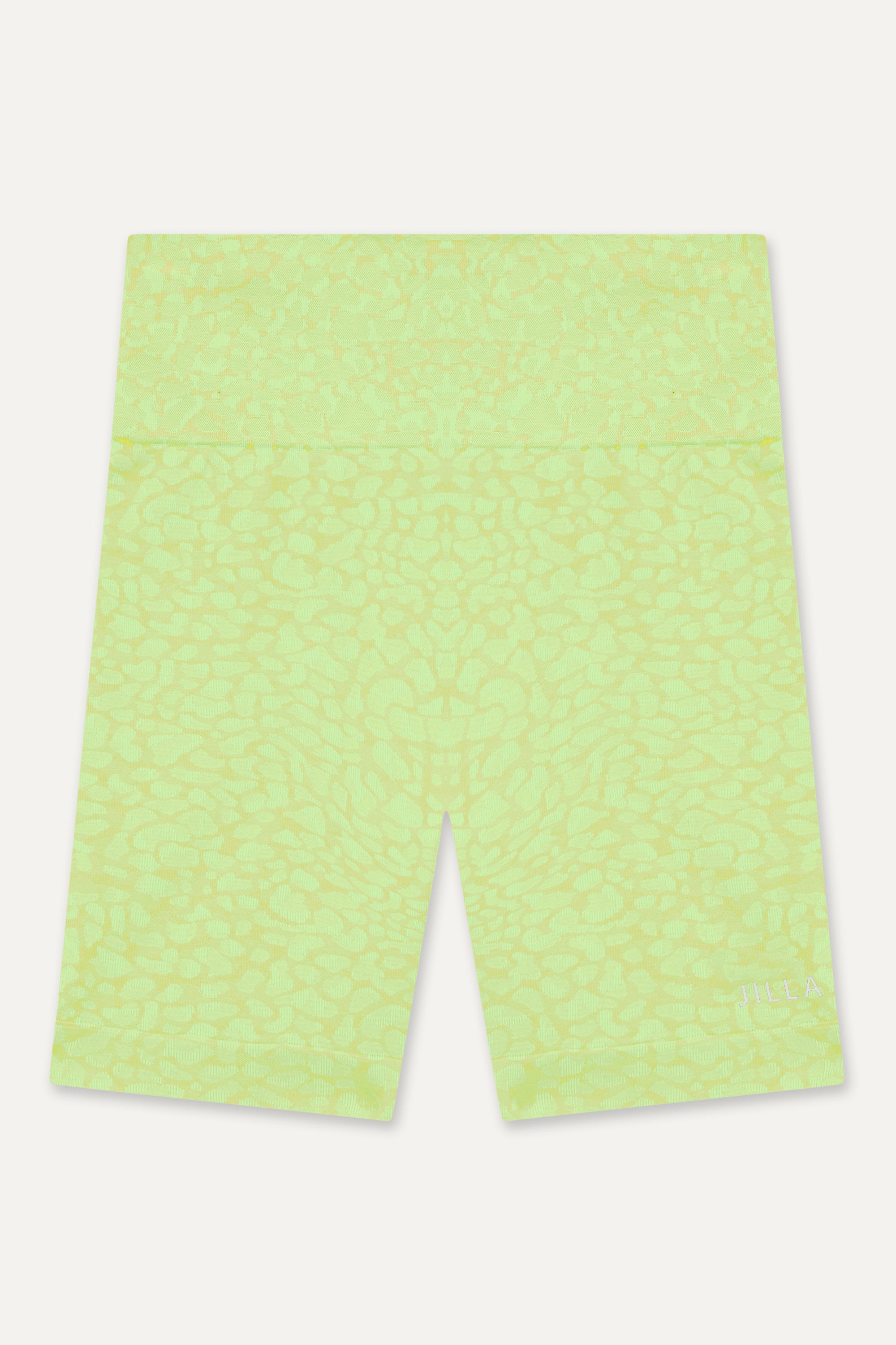 Prepare for summer with our Sahara Recycled Shorts in lime acid green, seamlessly knitted in our new animal jacquard. With a wide ribbed waistband and a mid-thigh finish, they're perfect for studio classes, gym workouts, and everyday style. The internal waistband elastic and four-way stretch fabric ensure they stay in place all day. Complete your look by pairing them with the matching bra and oversized tee.