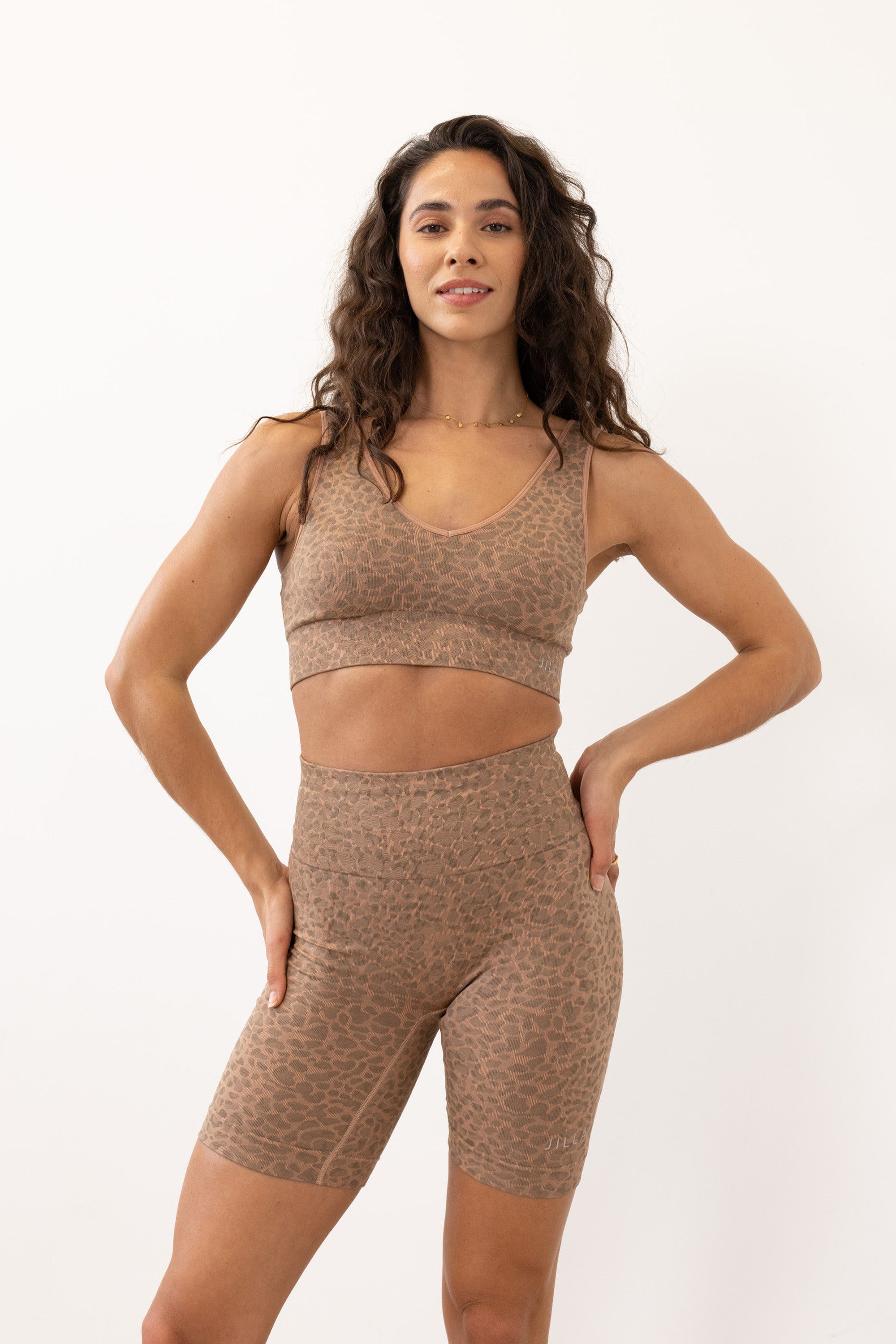 Prepare for summer with our Sahara Recycled Shorts, seamlessly knitted in our new animal jacquard. With a wide ribbed waistband and a mid-thigh finish, they're perfect for studio classes, gym workouts, and everyday style. The internal waistband elastic and four-way stretch fabric ensure they stay in place all day. Complete your look by pairing them with the matching bra and oversized tee.