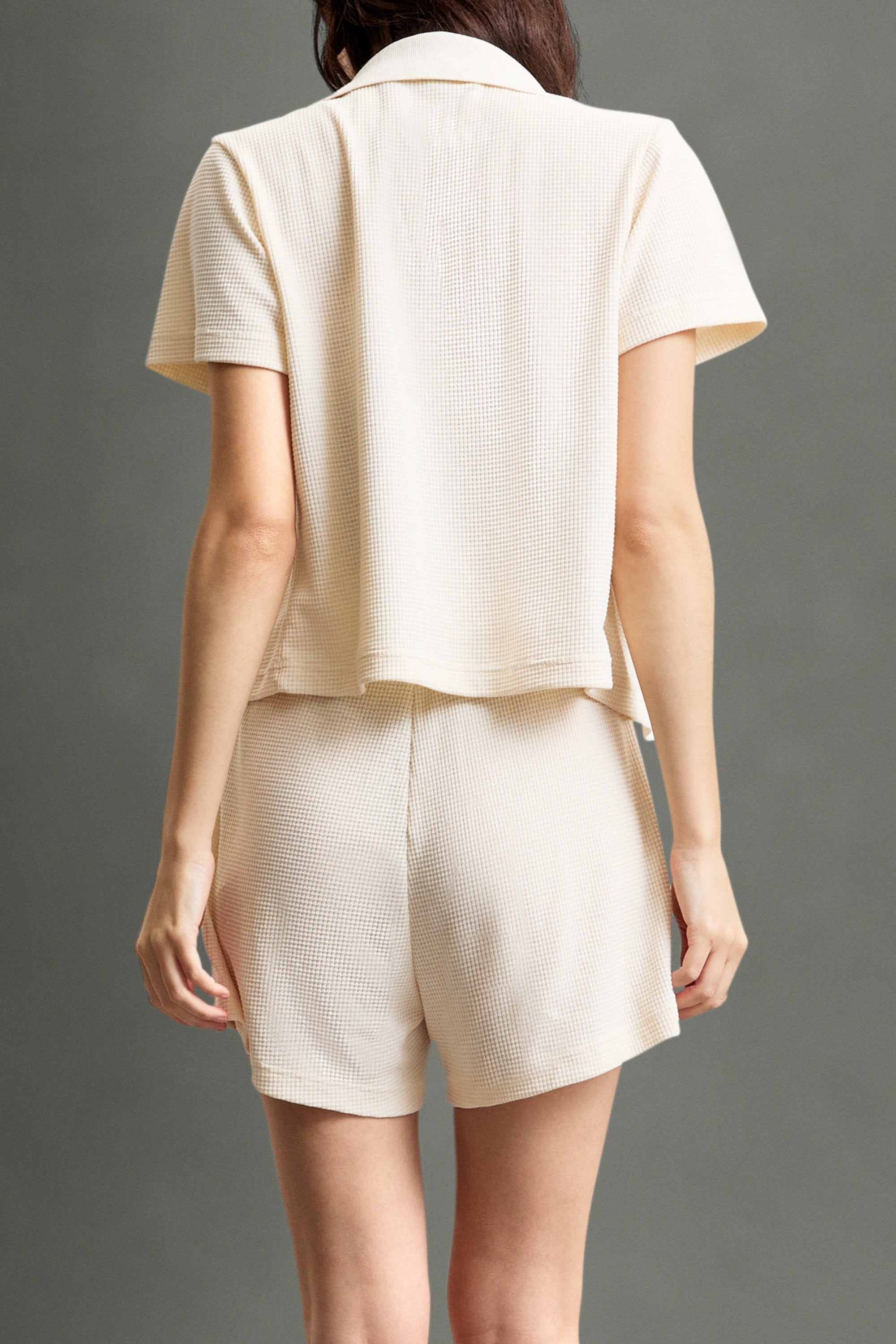 Women's HRMN8 beige cream off white resort-style waffle shorts, breathable textured fabric shorts, lightweight pull-on shorts, soft loungewear-inspired activewear, relaxed-fit summer shorts, easy layering gym shorts, versatile beach cover-up shorts, co-ord resort wear set, high-waisted casual shorts, premium athleisure shorts.