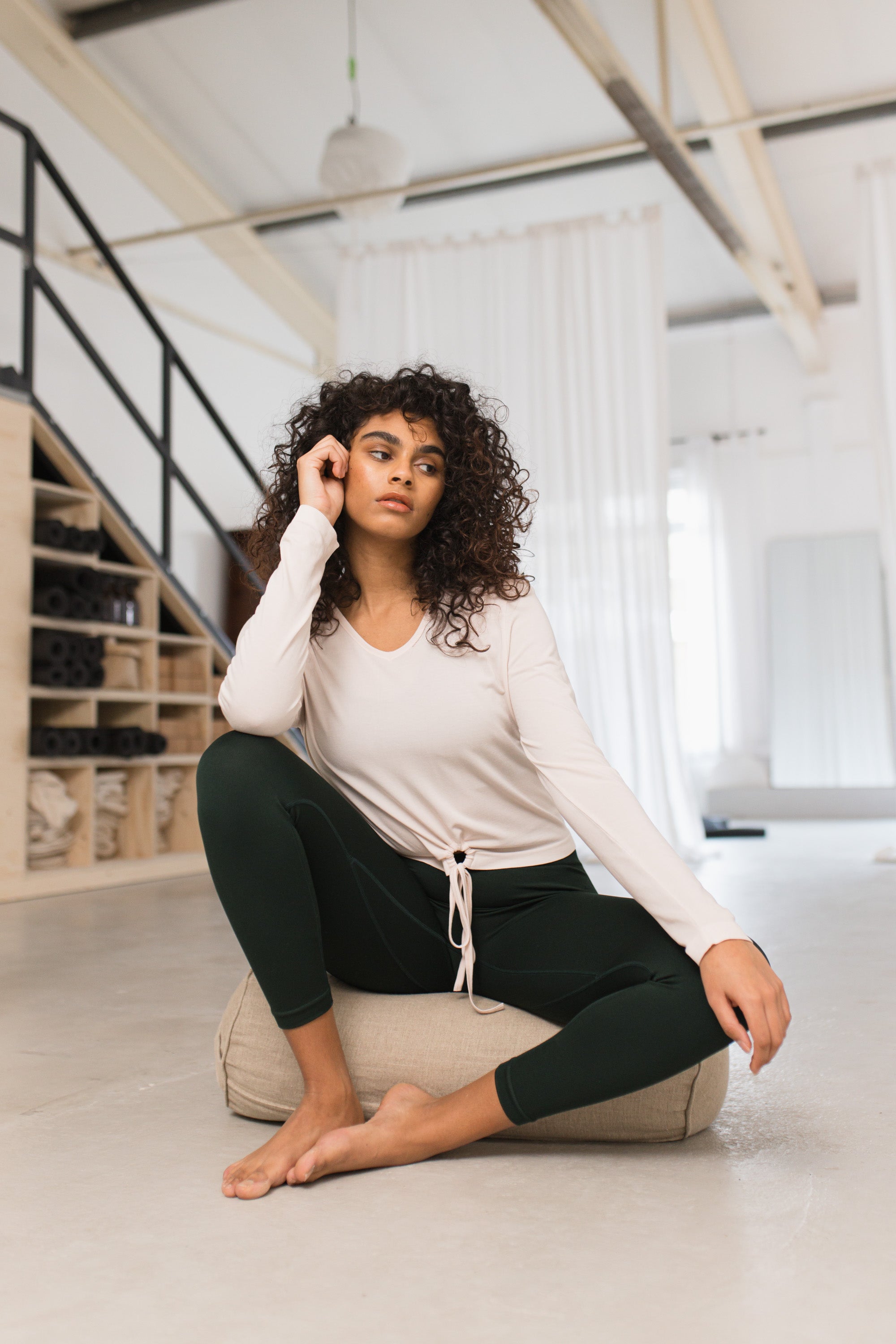 Light cream beige V neck bamboo recycled fabric long sleeve top with cooling and moisture wicking properties for yoga, barre, pilates, gym, and exercise.