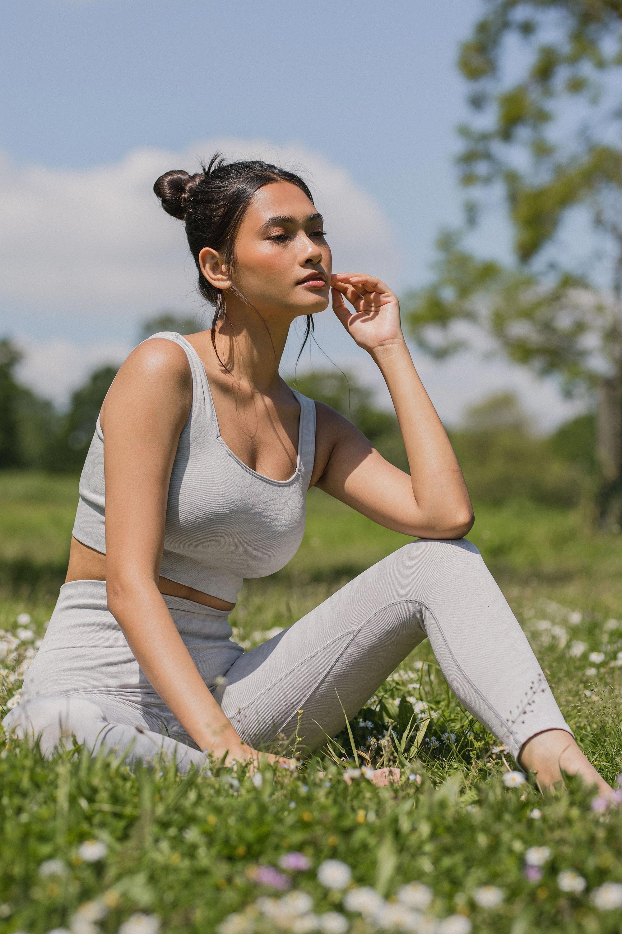 Grey cropped leggings and grey supportive sports bra.