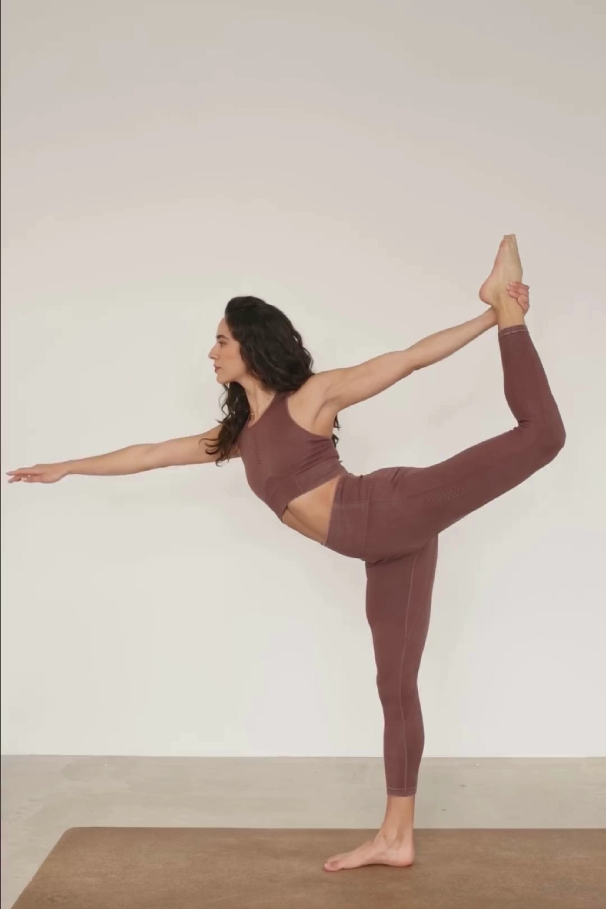 Meet our chocolate brown Aquarius Recycled Sports Bra - uniquely textured and stylish, perfect for yoga, barre, and more. Crafted from soft recycled seamless fabric, it offers light to medium support with a high neckline and statement back shape. Pair with our matching leggings for a seamless studio-to-street look. Enjoy versatile support and comfort, customizable with removable pads by sustainable activewear brand Jilla Active