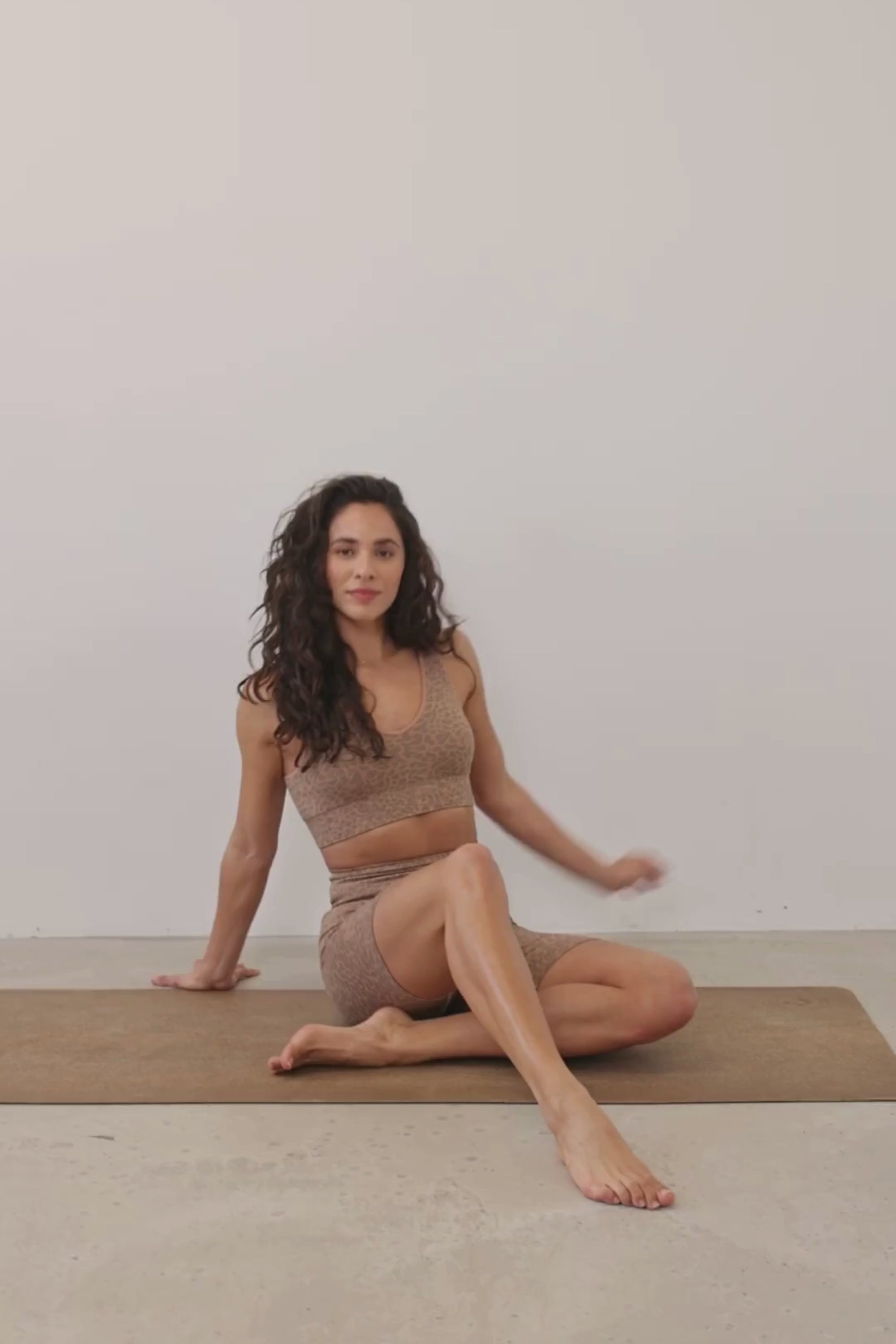 Get summer-ready with our brown Sahara Recycled Sports Bra, seamlessly knitted in our new animal jacquard. Designed with a flattering V-neck shape, comfortable straps, and a wide underband, this bra offers light to medium support for low-impact studio exercise, cycling, and gym sessions. The double-layered fabric ensures support and flexibility, while removable pads allow you to customize your fit. Pair it with the matching shorts for a studio-to-street look from sustainable activewear brand Jilla Active